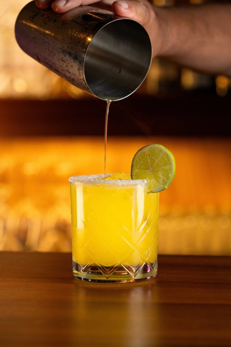 Bartender pouring a fresh cocktail at a sports bar in Nuevo Vallarta